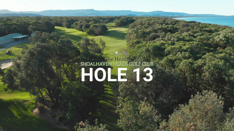 Hole 13 — Aerial view of the tree-lined fairway at The Heads, Shoalhaven Heads Golf Club, with native coastal bush framing the course and mountain & water views in the distance.