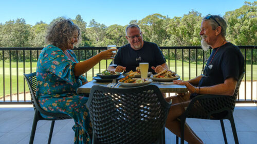 three people dining on the balcony at the Shoalhaven Heads Golf Club.